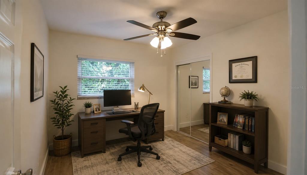 A home office features a wooden desk, an ergonomic chair, a bookshelf, and a ceiling fan — 2511 W VIOLET STREET, TAMPA, FL
