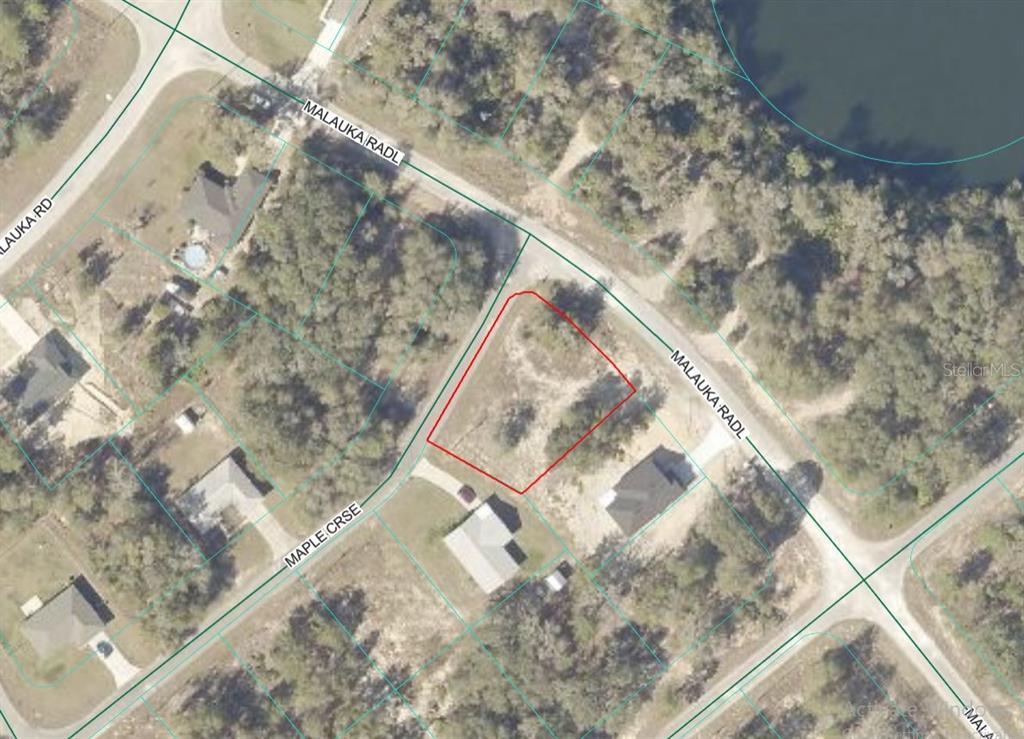 An aerial map view shows a vacant, rectangular residential lot outlined in red — Lot 1 MALUKA RADIAL, OCKLAWAHA, FL