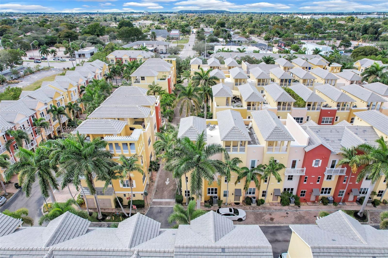 An aerial view shows a dense residential complex of multi-story townhomes with palm trees — 2318 Vintage Dr # 2318, Lighthouse Point FL 33064, LIGHTHOUSE POINT, FL
