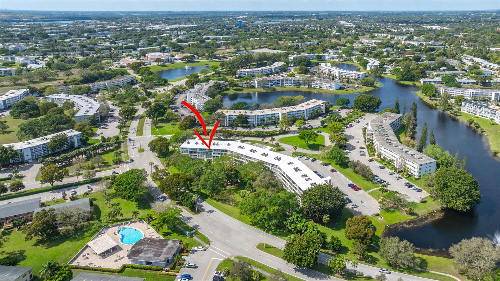 An aerial view shows a multi-story apartment building with a red arrow pointing toward it — 4002 Cambridge A # 4002, Deerfield Beach FL 33442, DEERFIELD BEACH, FL