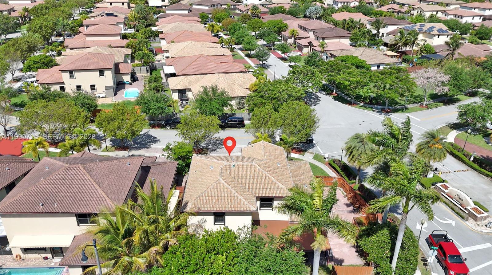An aerial view shows a residential house with a tiled roof and a red location pin — 3698 SE 2nd Dr, Homestead FL 33033, HOMESTEAD, FL