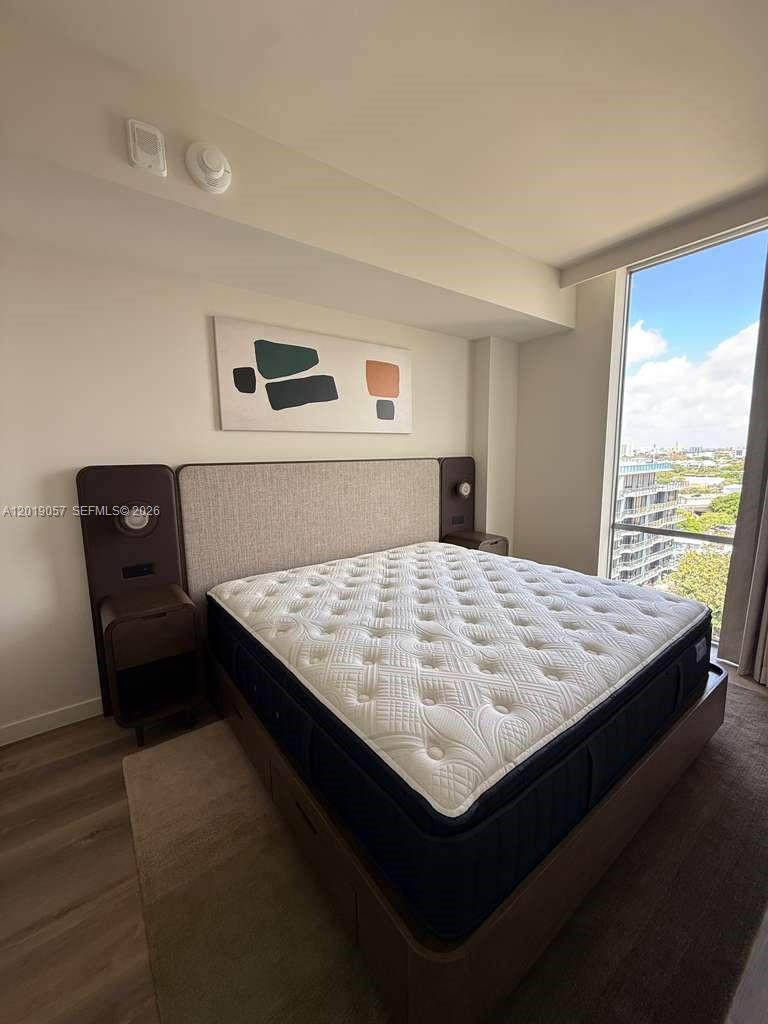 A bedroom features a platform bed with integrated nightstands, a neutral headboard, and floor-to-ceiling windows — 1611 SW 2nd ave # 911, Miami FL 33129, MIAMI, FL