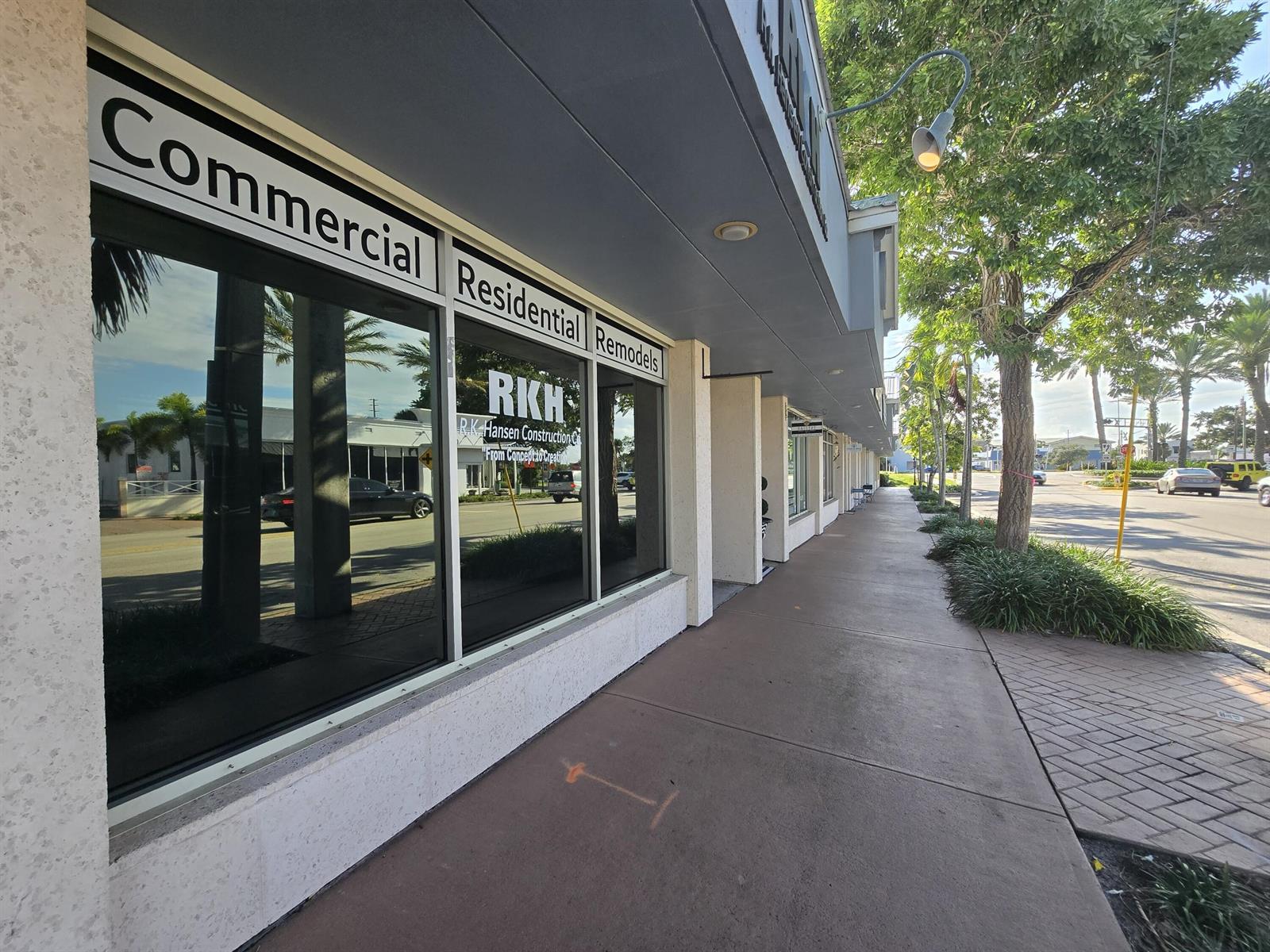 A storefront with large glass windows featuring R.K. Hansen Construction signage along a sidewalk — 38 SE Ocean Boulevard # 38, Stuart FL 34994, STUART, FL