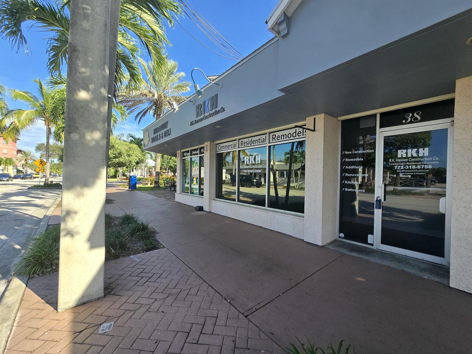 The exterior of a commercial building features a storefront with signage for a construction company — 38 SE Ocean Boulevard # 38, Stuart FL 34994, STUART, FL
