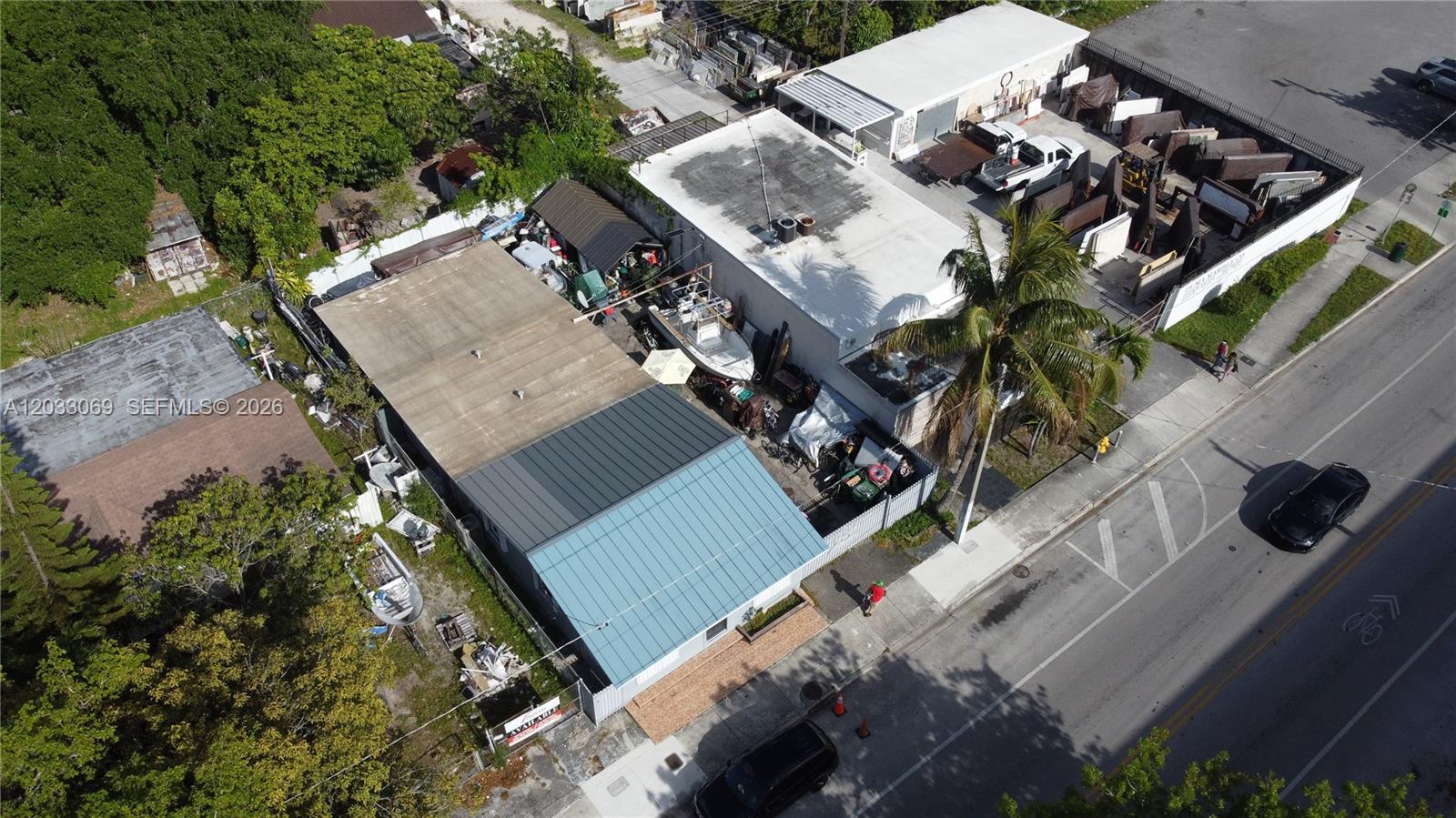 An aerial view shows two commercial buildings with outdoor storage areas and a nearby road — 5501 NW 2nd Ave, Miami FL 33127, MIAMI, FL