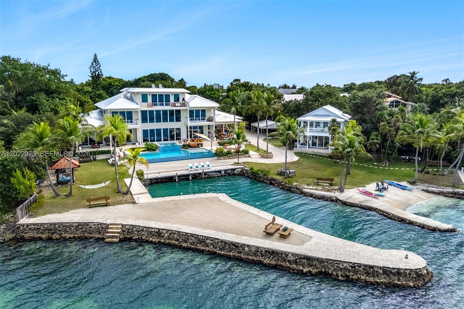 An aerial view shows a large waterfront estate with a swimming pool and private dock — 82768 Overseas Highway, Islamorada FL 33036, ISLAMORADA, FL