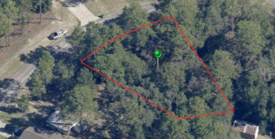 An aerial view shows a wooded, irregularly shaped vacant lot outlined in red — 9331 N MARCUS WAY, CITRUS SPRINGS, FL