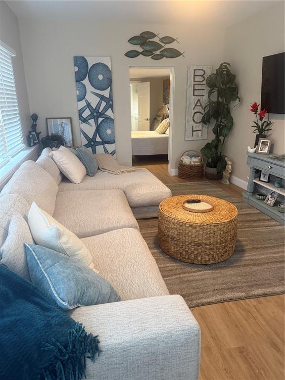 A living room features a large sectional sofa, a round woven coffee table, and beach-themed decor — 2849 MARLETTE STREET, SARASOTA, FL