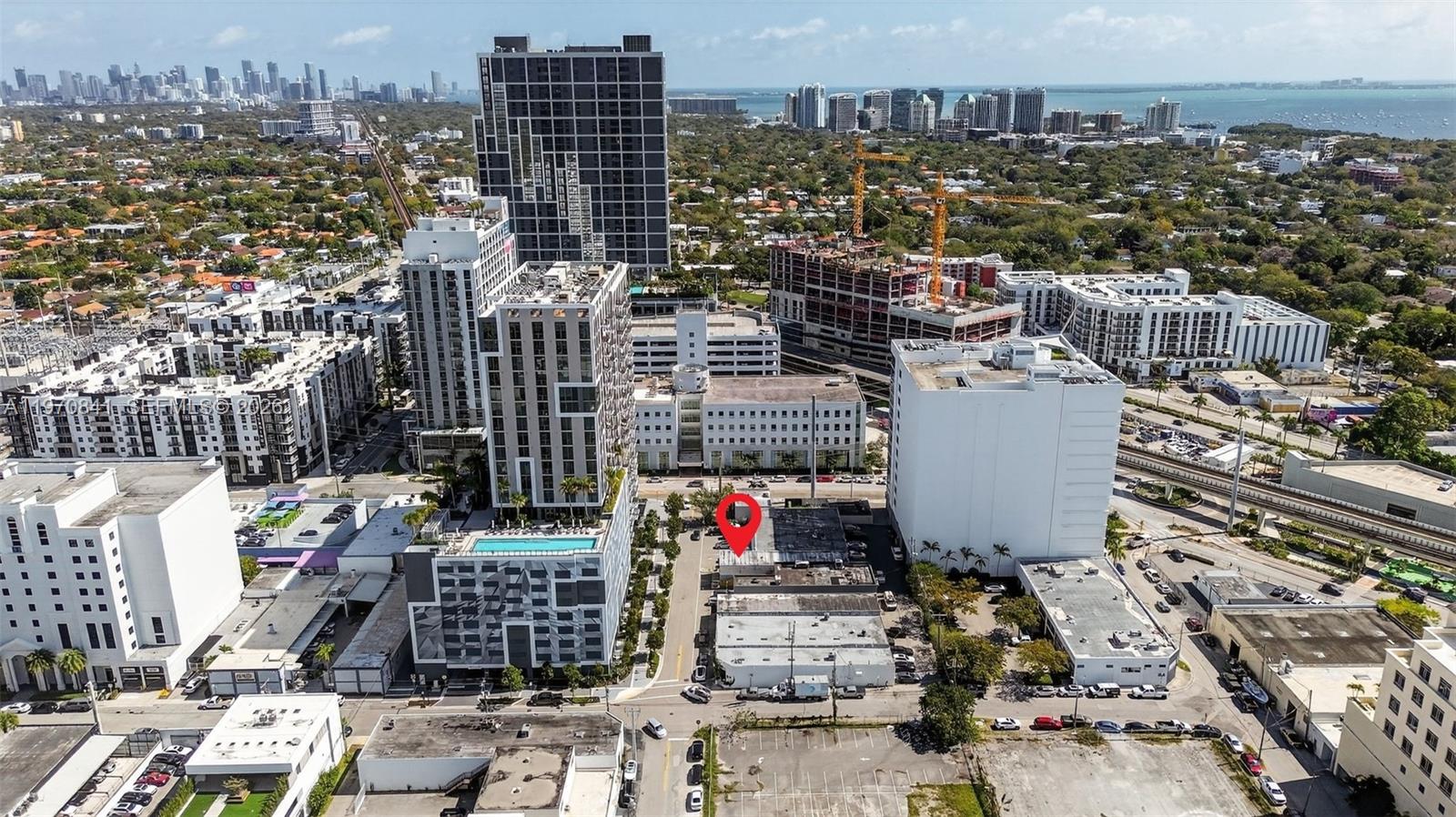 An aerial view shows a city neighborhood with a red pin marking a low-rise building — 3838 Shipping Ave, Miami FL 33146, MIAMI, FL