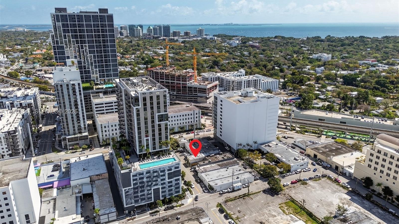 An aerial view shows a city neighborhood with high-rise buildings and a red location marker — 3838 Shipping Ave, Miami FL 33146, MIAMI, FL