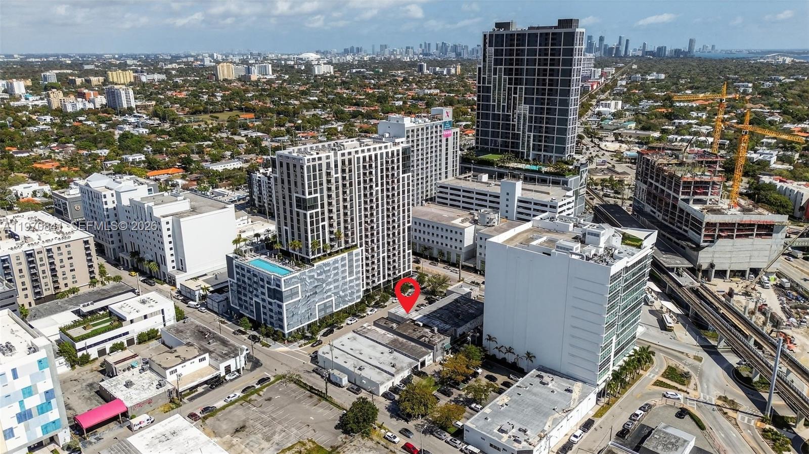 An aerial view shows a city neighborhood with a red pin marking a low-rise building — 3838 Shipping Ave, Miami FL 33146, MIAMI, FL