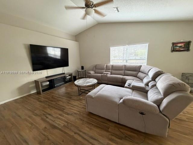 A living room features a large sectional sofa, a wall-mounted television, and wood-look flooring — 330 Sterling Drive, Winter Haven FL 33884, WINTER HAVEN, FL