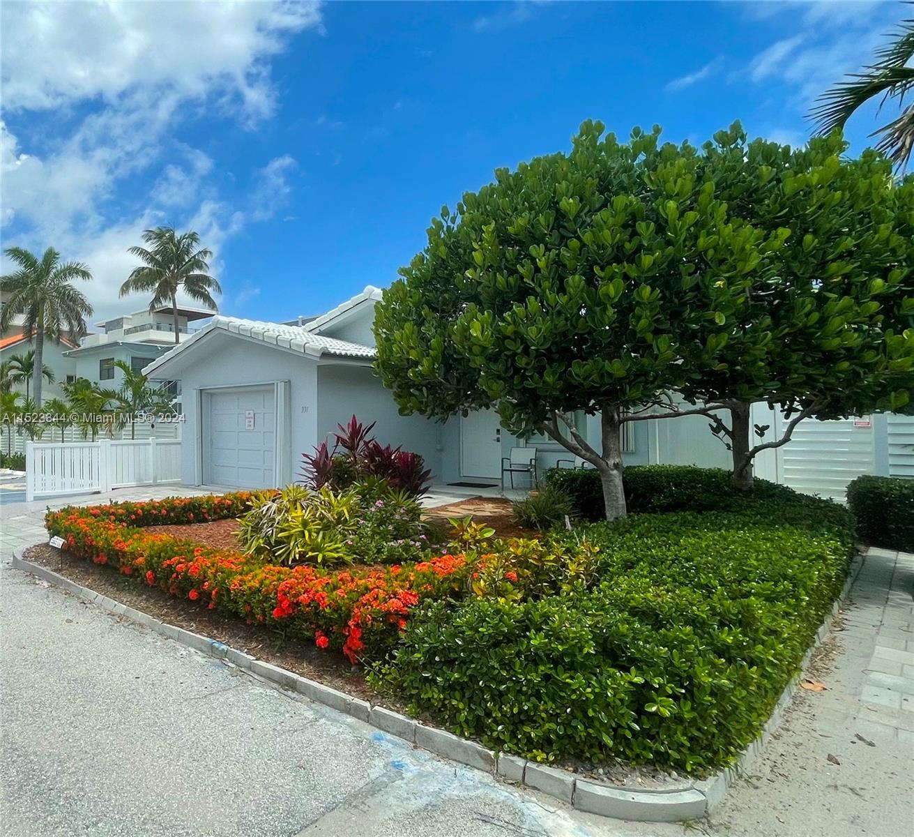 A single-story house features a garage, a landscaped front yard, and a large tree — 331 Desoto St, Hollywood FL 33019, HOLLYWOOD, FL