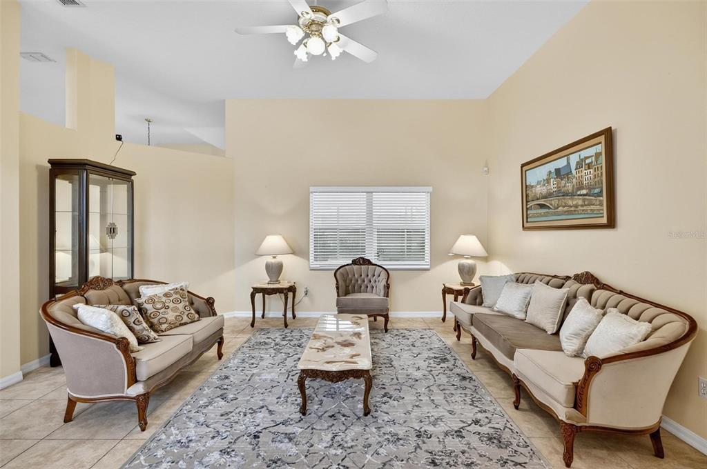 A formal living room features two sofas, a central armchair, and a marble coffee table — 3 WALLA PLACE, PALM COAST, FL