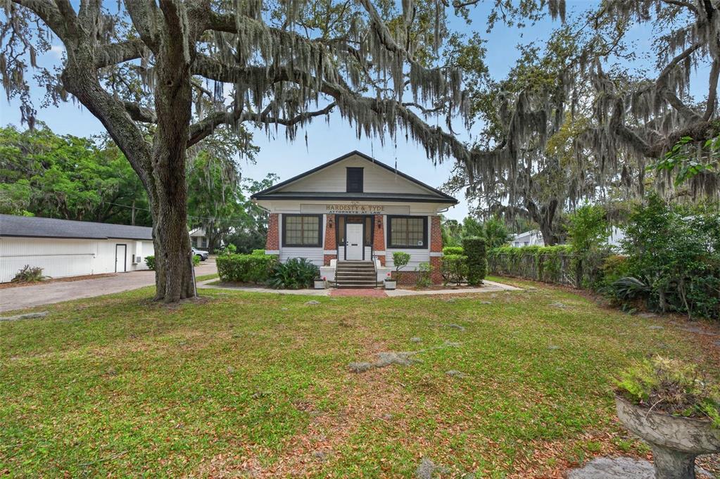 A single-story brick and siding office building sits behind a large oak tree — 4004 ATLANTIC BOULEVARD, JACKSONVILLE, FL