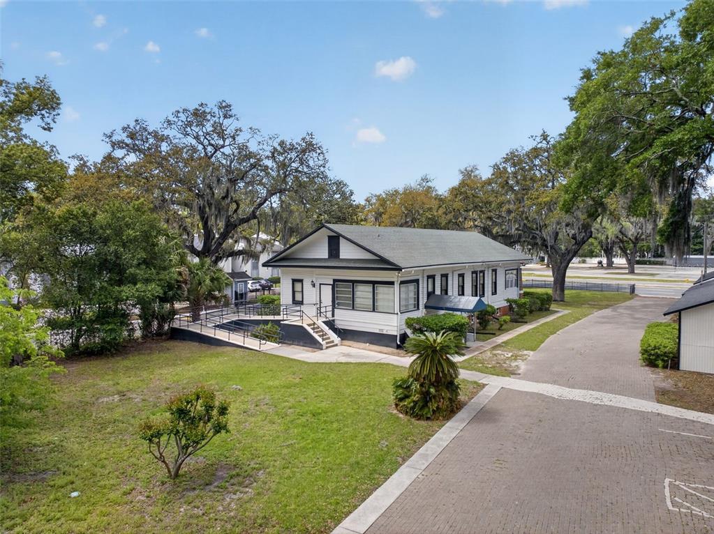 A white single-story building with a black roof and an accessible ramp sits on grass — 4004 ATLANTIC BOULEVARD, JACKSONVILLE, FL