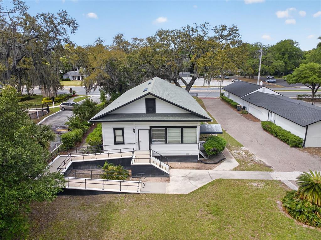 An exterior view of a white house with a wheelchair ramp and a detached garage — 4004 ATLANTIC BOULEVARD, JACKSONVILLE, FL
