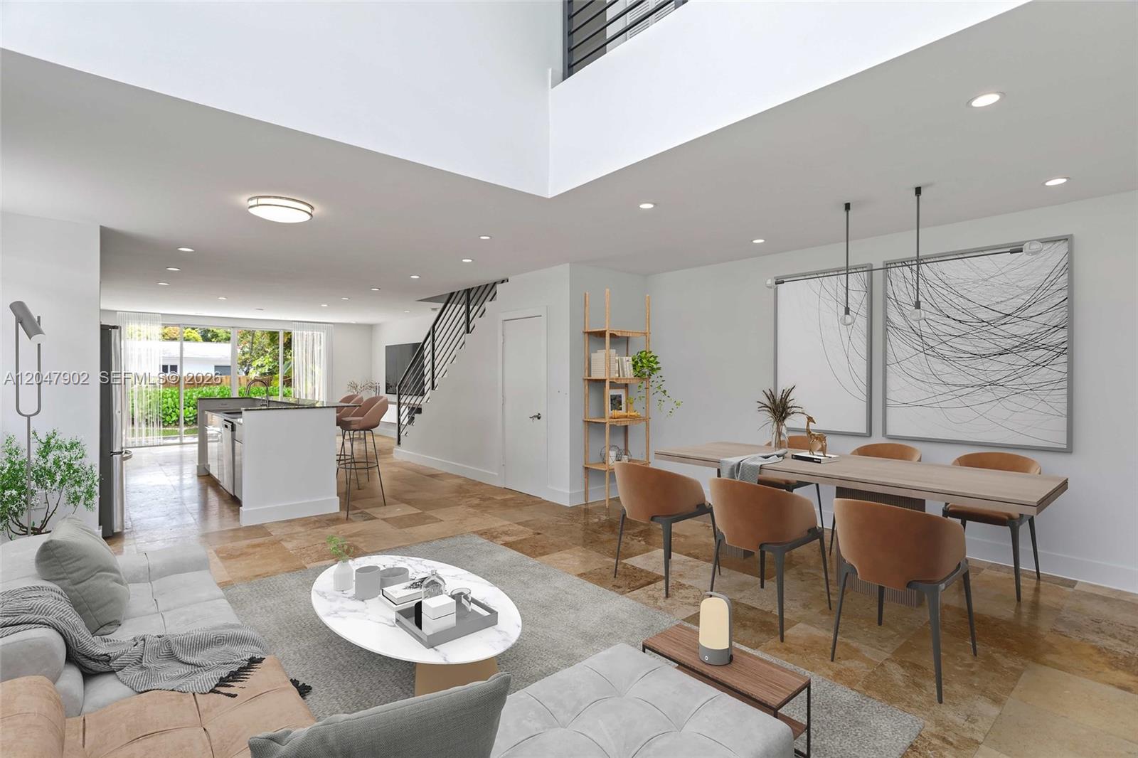 This open-concept living and dining area features tile flooring, a staircase, and high ceilings — 7004 NE 5th Ave, Miami FL 33138, MIAMI, FL