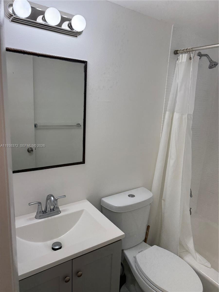 A bathroom features a vanity with a sink, a toilet, and a shower-tub combination — 740 Michigan Ave # 5, Miami Beach FL 33139, MIAMI BEACH, FL