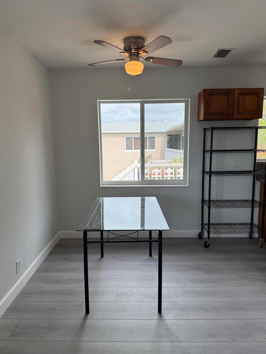 A two-story apartment building exterior with a white staircase, palm trees, and a grassy lawn — 510 SW 15th Street # 204, Pompano Beach FL 33060, POMPANO BEACH, FL
