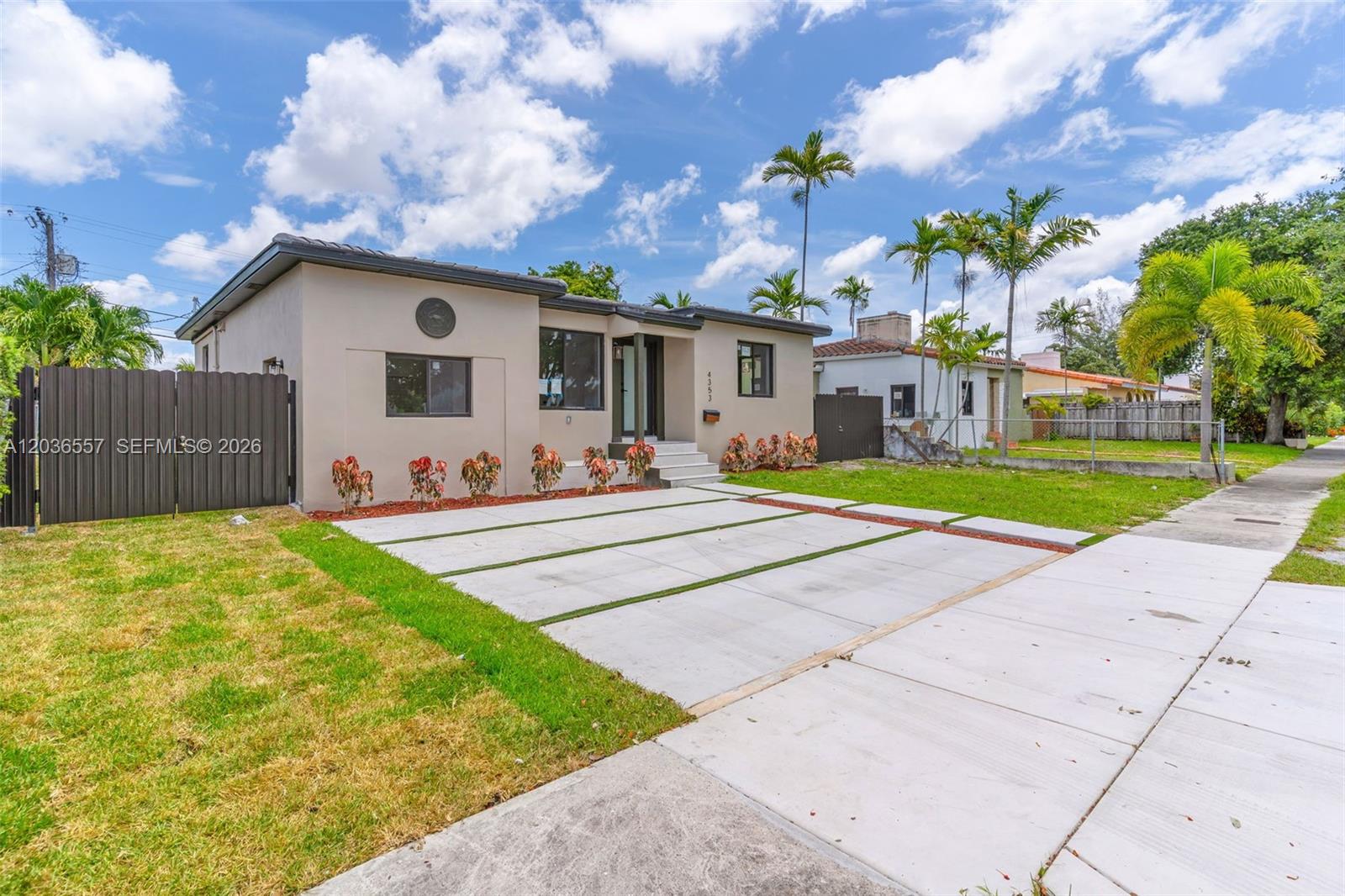 A single-story house with a concrete driveway, a fenced yard, and palm trees — 4353 SW 2nd St, Miami FL 33134, MIAMI, FL