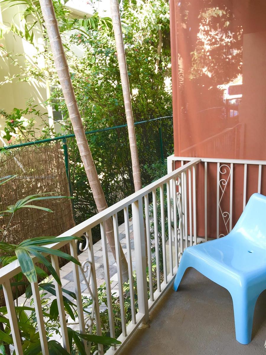 A light blue plastic chair sits on a balcony with a white metal railing — 1228 Pennsylvania Ave # 2, Miami Beach FL 33139, MIAMI BEACH, FL
