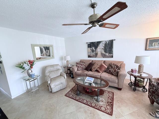 A living room features a beige sofa, a recliner, a ceiling fan, and tile flooring — 174 Prescott I, Deerfield Beach FL 33442, DEERFIELD BEACH, FL