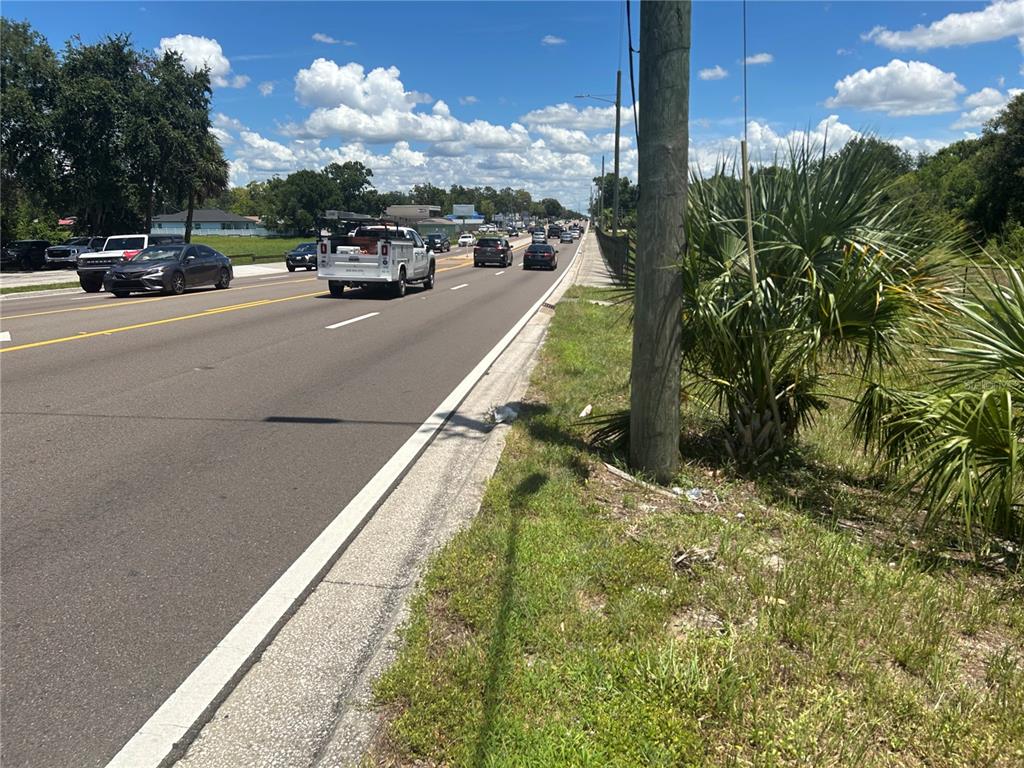 A view of a multi-lane road with traffic and a utility pole on the right — 1904-1906 W BUSCH BOULEVARD, TAMPA, FL