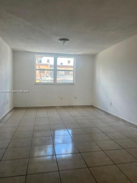 An empty room with white walls, a tiled floor, and a window facing outside — 666 W 81st St # 103, Hialeah FL 33014, HIALEAH, FL