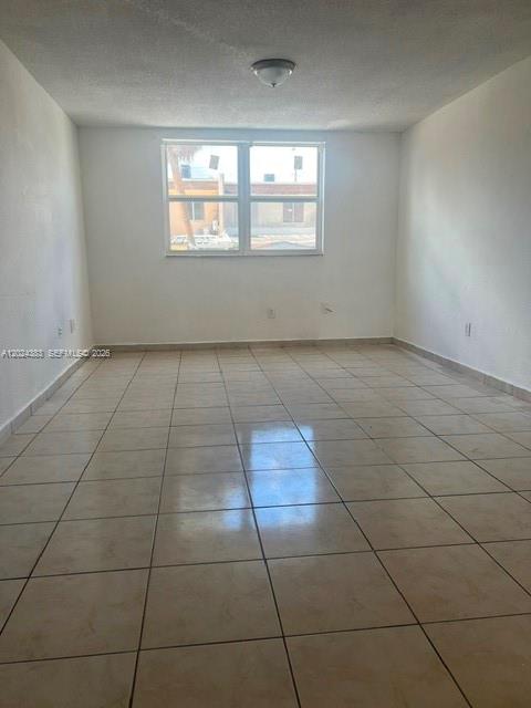 An empty room features light-colored tile flooring, white walls, and a single window — 666 W 81st St # 103, Hialeah FL 33014, HIALEAH, FL