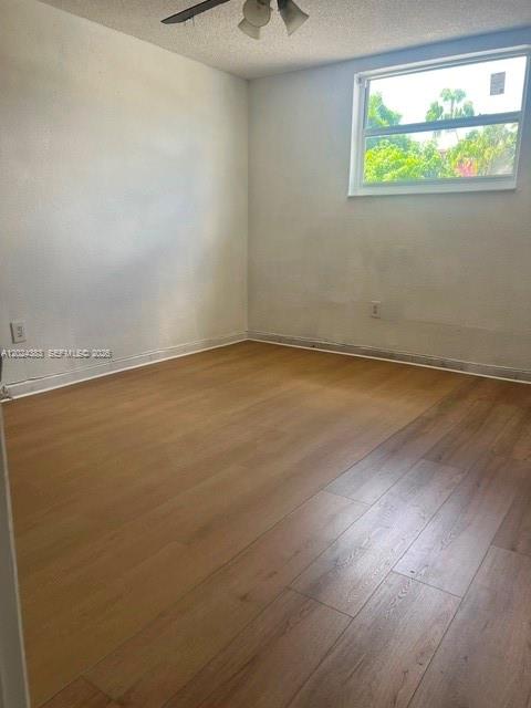 An empty bedroom features light wood-look flooring, white walls, and a single window — 666 W 81st St # 103, Hialeah FL 33014, HIALEAH, FL