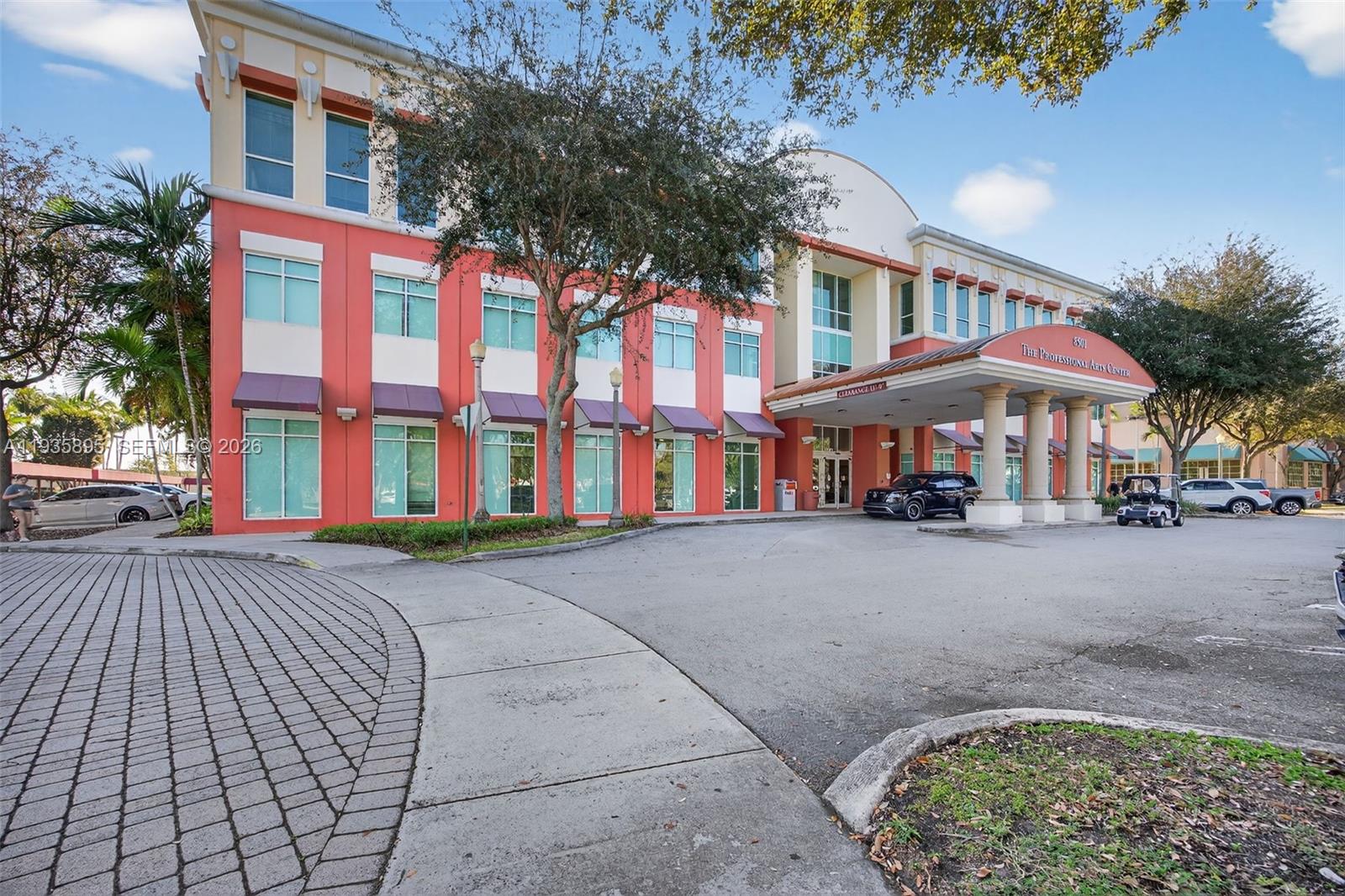 A three-story commercial building with a red facade and a covered entrance portico — 8501 SW 124th Ave # 201, Miami FL 33183, MIAMI, FL