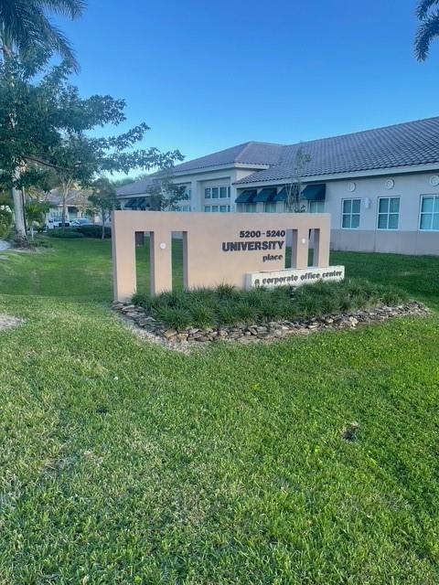 A tan monument sign stands in front of a single-story corporate office building — 5220 University Drive # 109c, Davie FL 33328, DAVIE, FL