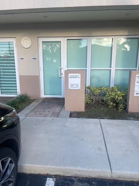 An exterior view of a commercial building entrance with a glass door and windows — 5220 University Drive # 109c, Davie FL 33328, DAVIE, FL