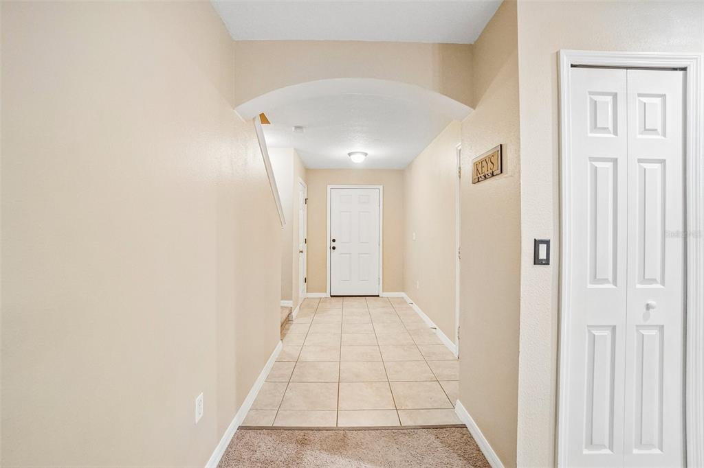 A tiled entryway leads to a white front door under an arched ceiling — 2516 OLEANDER LAKES DRIVE, BRANDON, FL