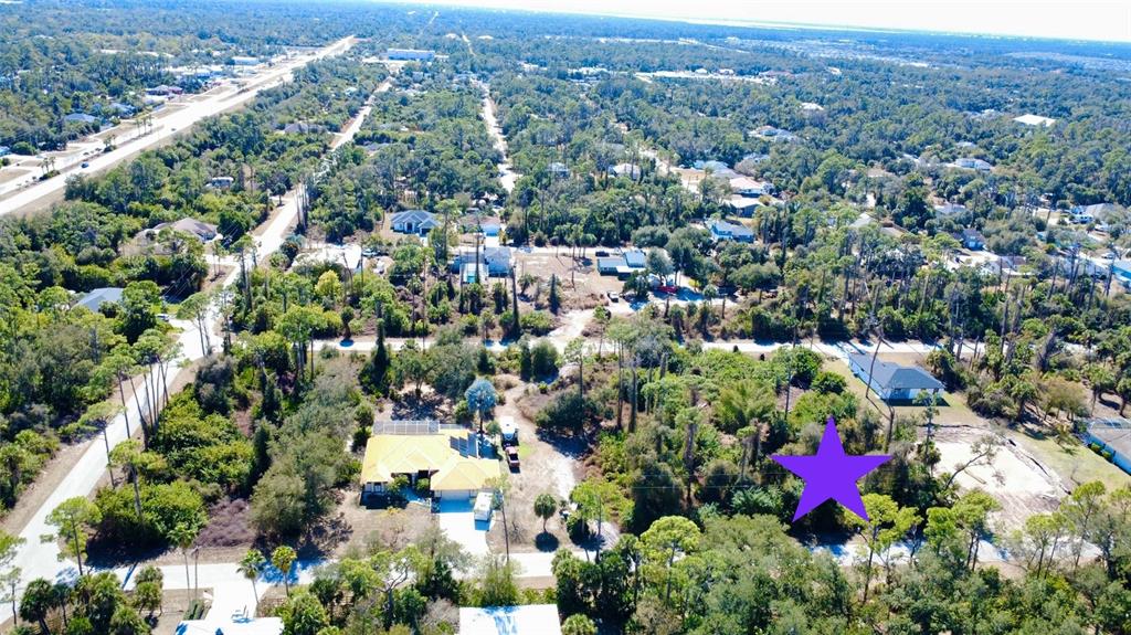 An aerial view of a wooded residential neighborhood with a purple star marking a lot — 17213 FALLKIRK AVENUE, PORT CHARLOTTE, FL