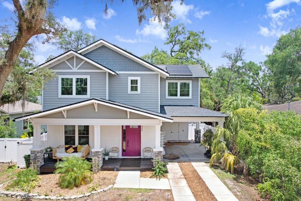 A two-story house with gray siding, a covered front porch, and a bright pink door — 920 E SHADOWLAWN AVENUE, TAMPA, FL