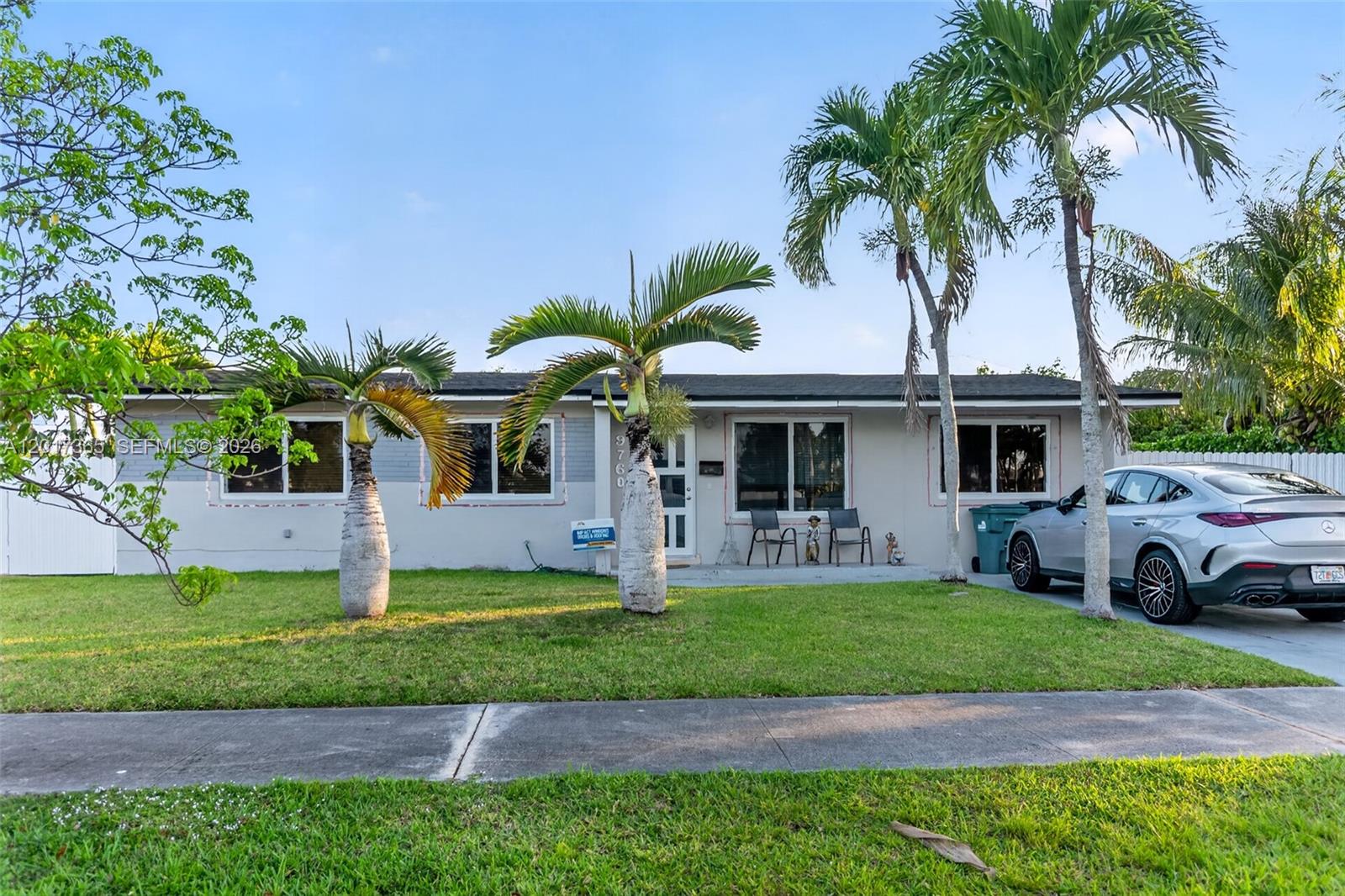 A single-story house with a light gray facade, palm trees, and a parked silver car — 9760 Memorial Rd, Cutler Bay FL 33157, CUTLER BAY, FL
