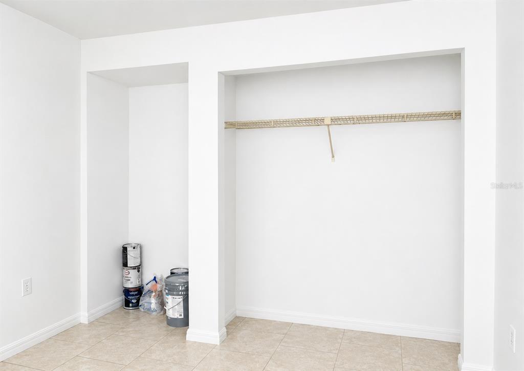 A room features two recessed closet spaces with white walls and light-colored tile flooring — 1068 LOTUS PARKWAY UNIT 815, ALTAMONTE SPRINGS, FL