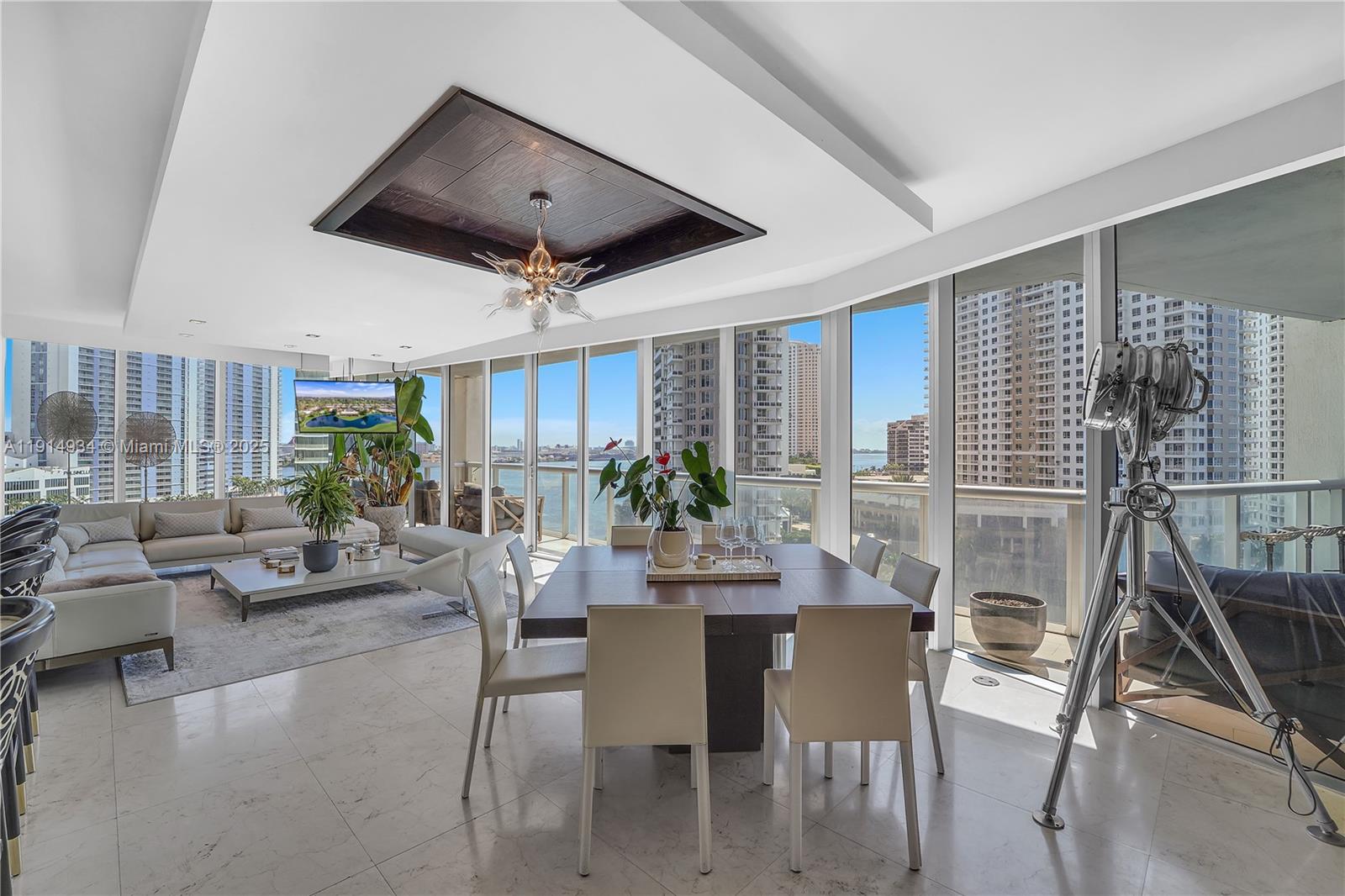 A modern living and dining area features marble floors, floor-to-ceiling windows, and a coffered ceiling — 465 Brickell Ave # 1001, Miami FL 33131, MIAMI, FL