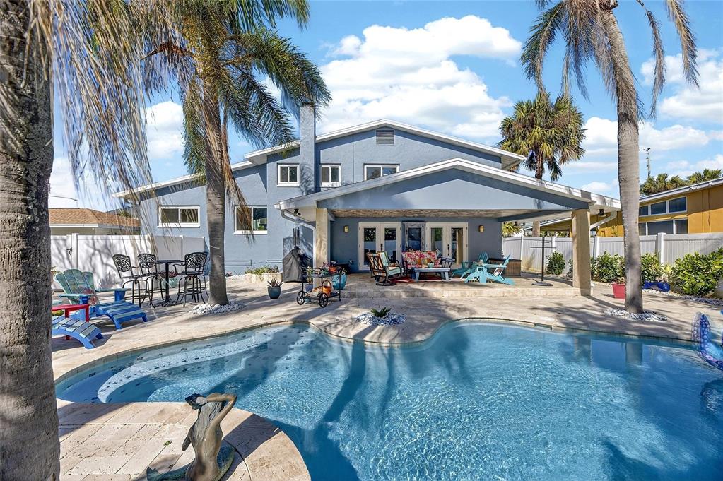 A blue two-story house with a covered patio, swimming pool, and palm trees in back — 931 GULF BOULEVARD, BELLEAIR BEACH, FL