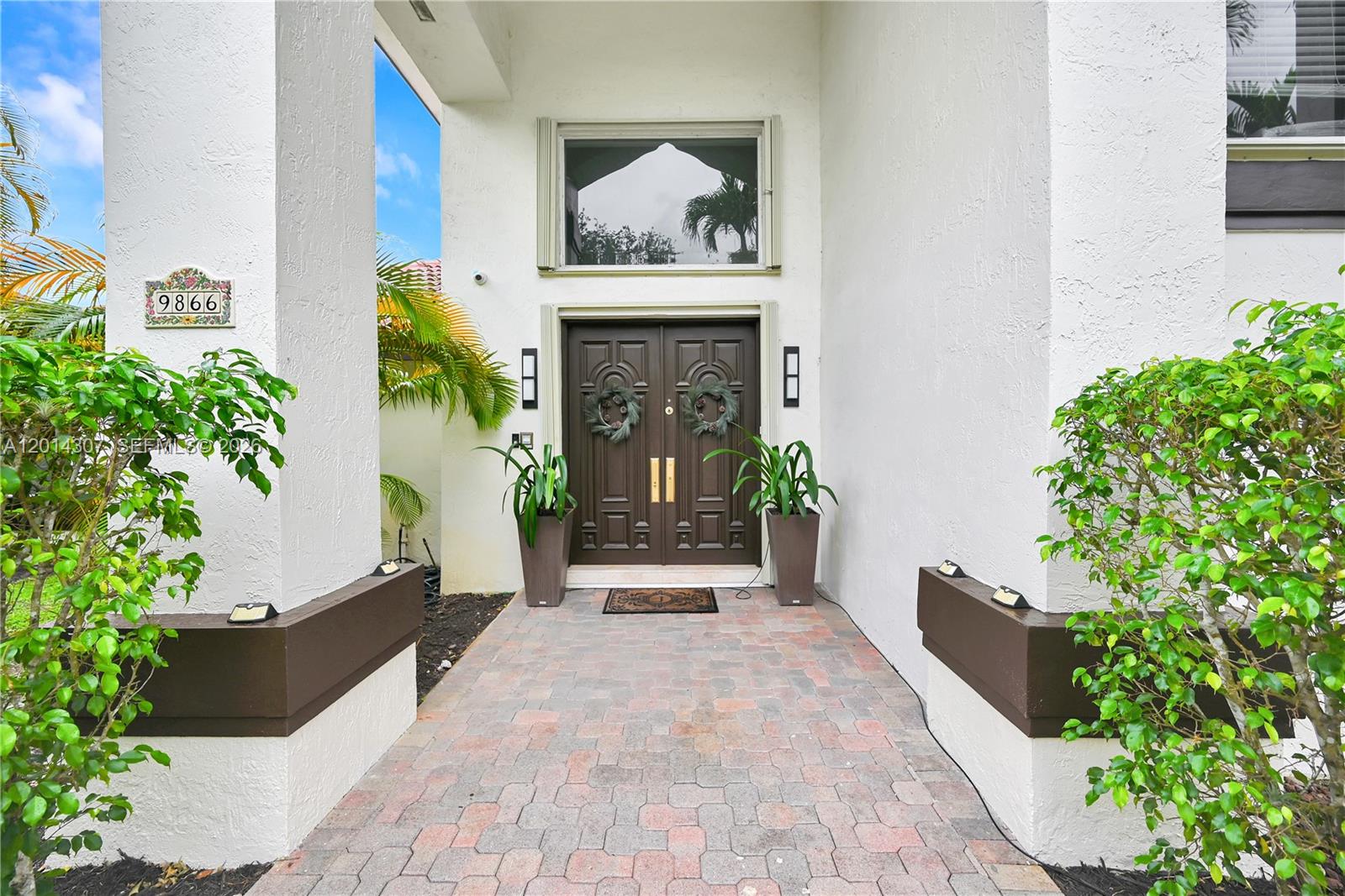 The front entrance features a double door with wreaths, potted plants, and a paved walkway — 9866 SW 111th Ter, Miami FL 33176, MIAMI, FL