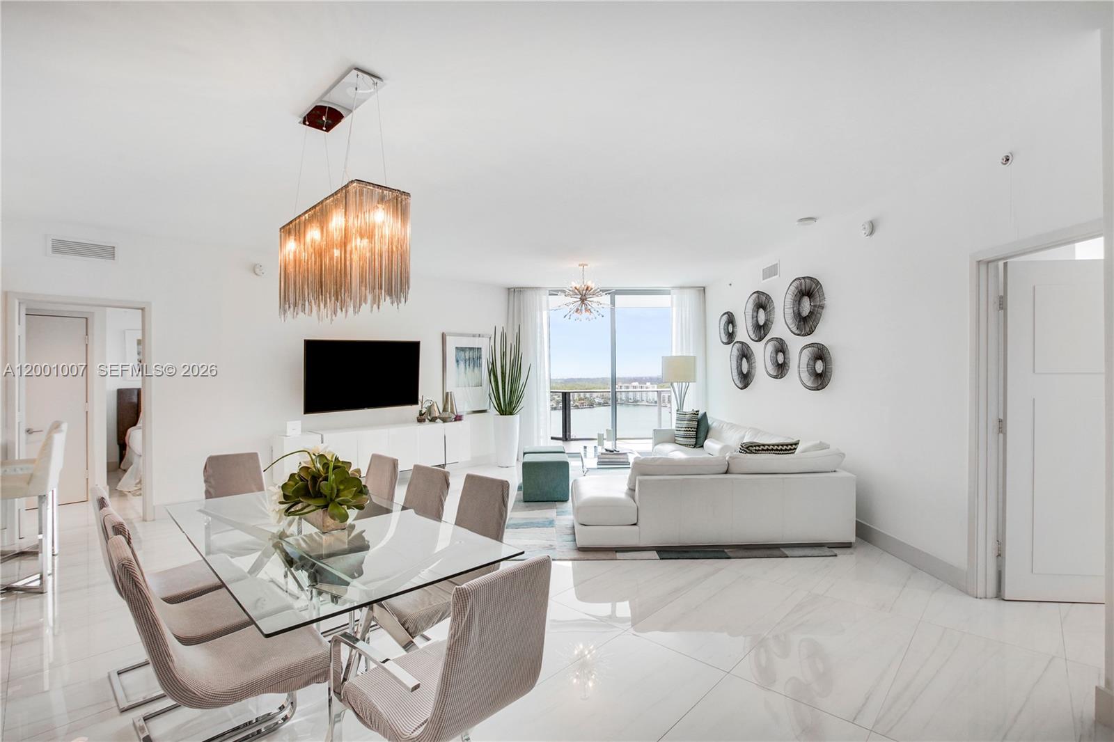 A modern open-plan living and dining area features white tile floors and a balcony view — 17111 Biscayne Blvd # 2008, North Miami Beach FL 33160, NORTH MIAMI BEACH, FL