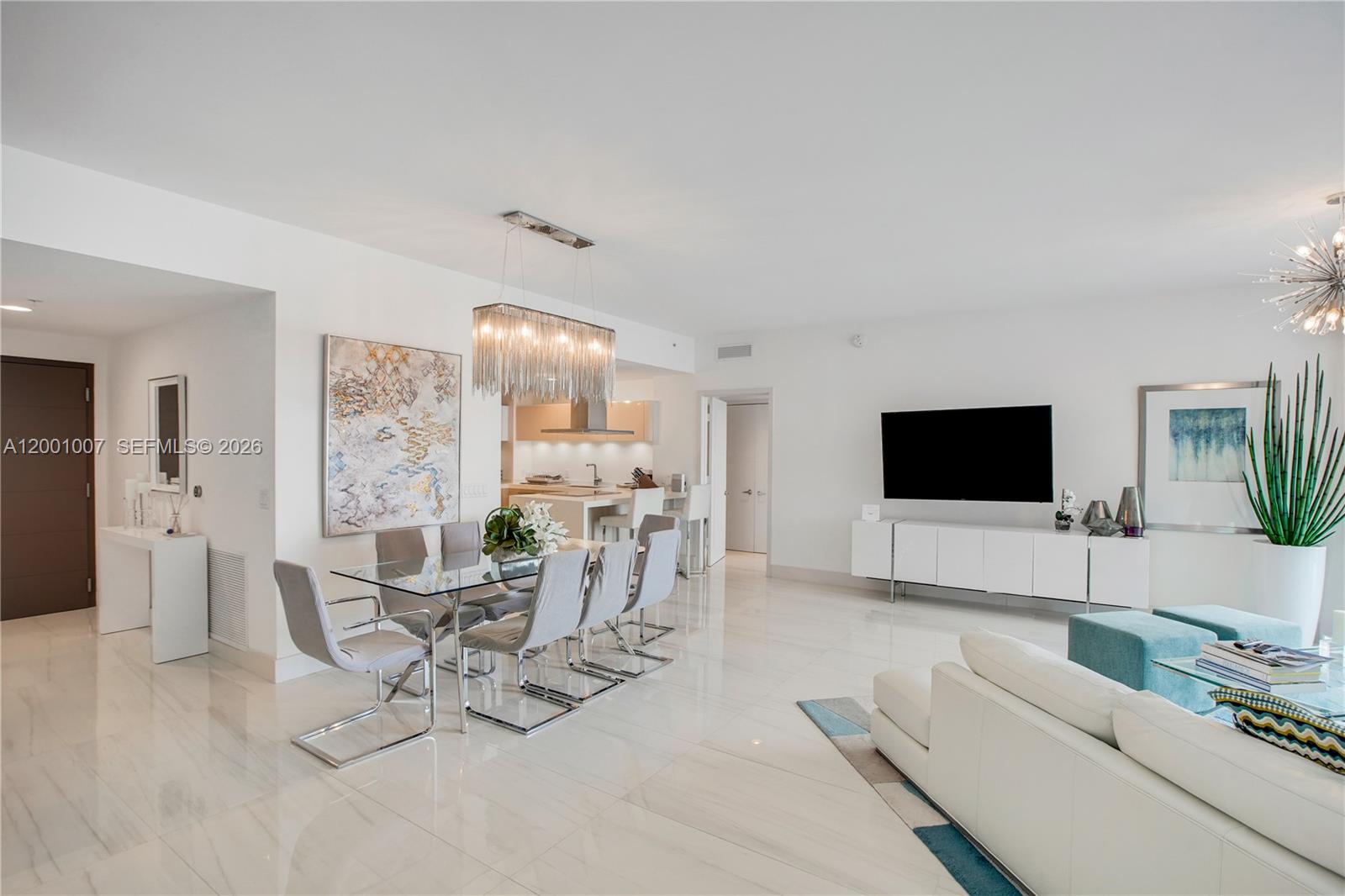 A modern, open-concept living and dining area features white tile floors and contemporary furniture — 17111 Biscayne Blvd # 2008, North Miami Beach FL 33160, NORTH MIAMI BEACH, FL