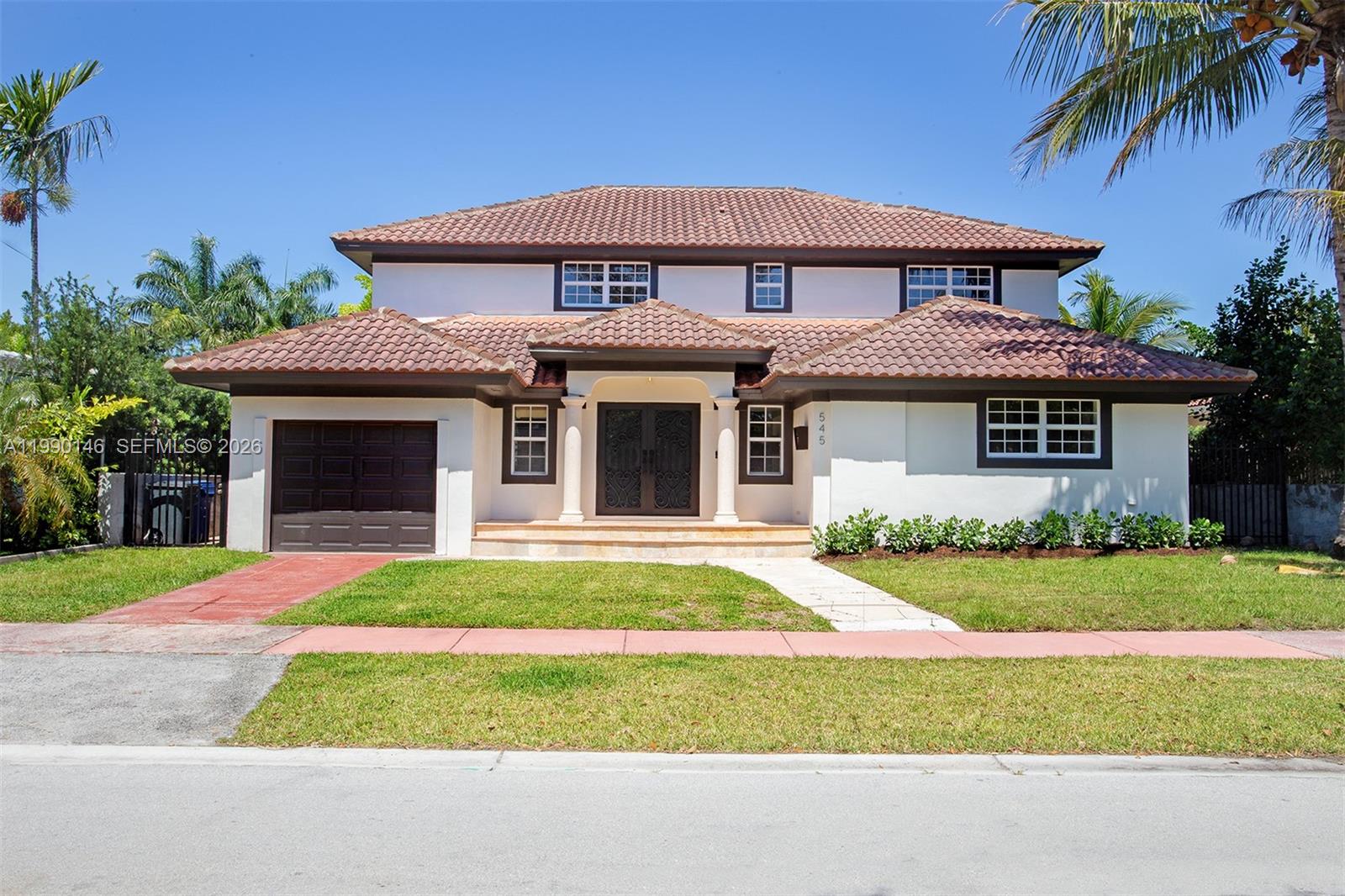 A two-story house with a backyard pool, patio furniture, and a second-floor balcony — 545 S Shore Dr, Miami Beach FL 33141, MIAMI BEACH, FL