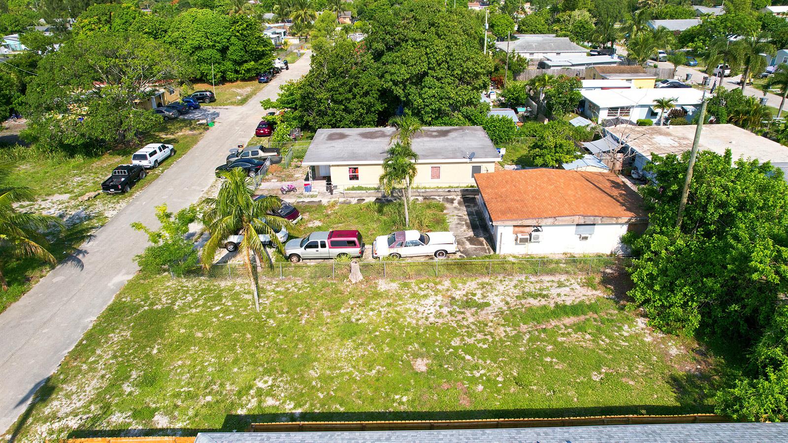 An aerial view shows two single-story houses with parked cars on a grassy lot — 1141 Peak Road, Lake Worth FL 33462, LAKE WORTH, FL