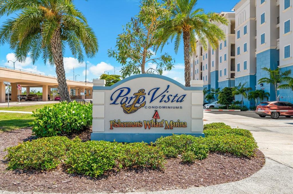 A sign for Porto Vista Condominiums and Fisherman's Wharf Marina stands in front of buildings — 507 TAMIAMI TRAIL N UNIT 602, VENICE, FL