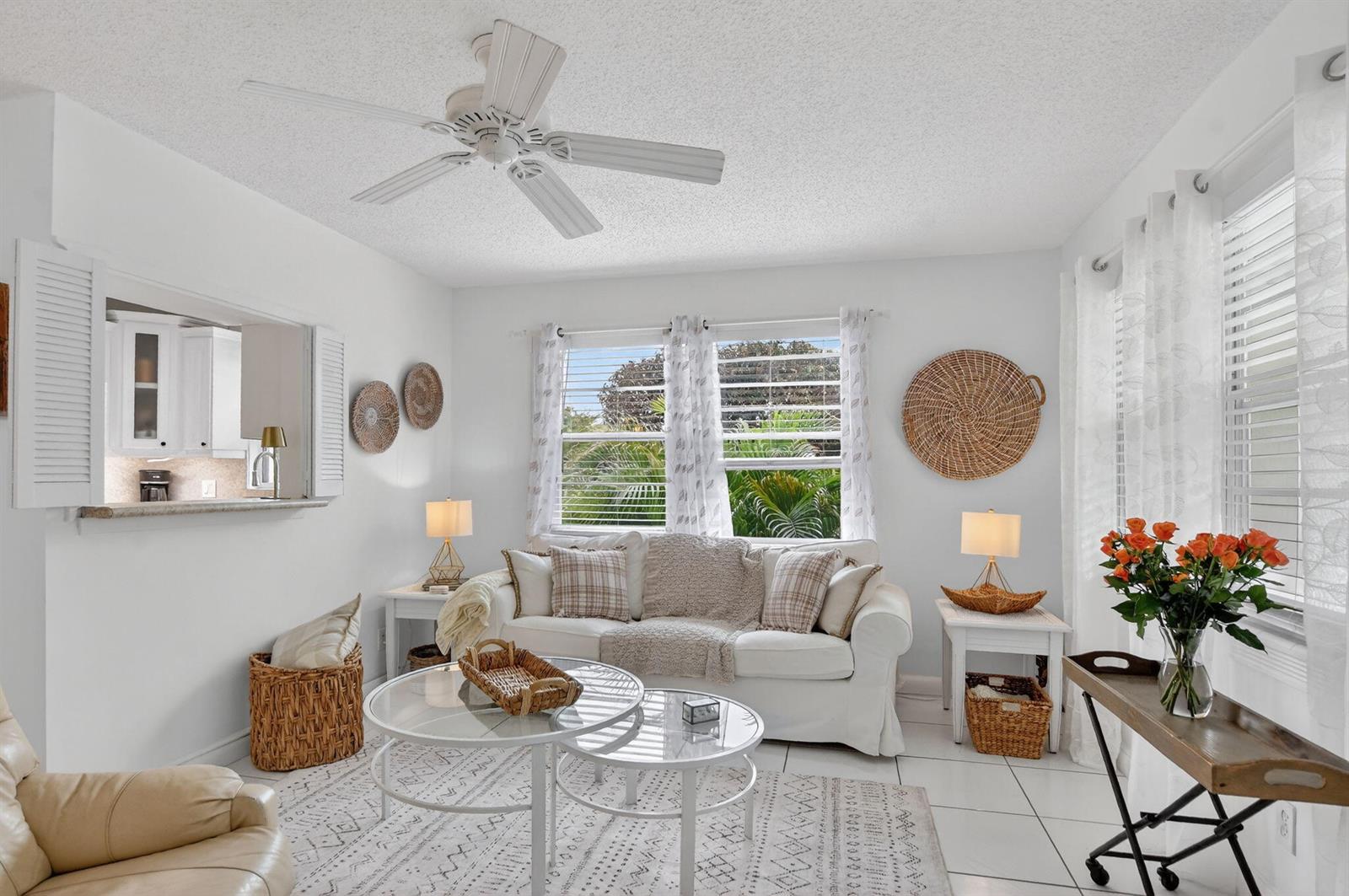 A bright living room features white walls, tile floors, a ceiling fan, and a sofa — 477 Tilford V, Deerfield Beach FL 33442, DEERFIELD BEACH, FL