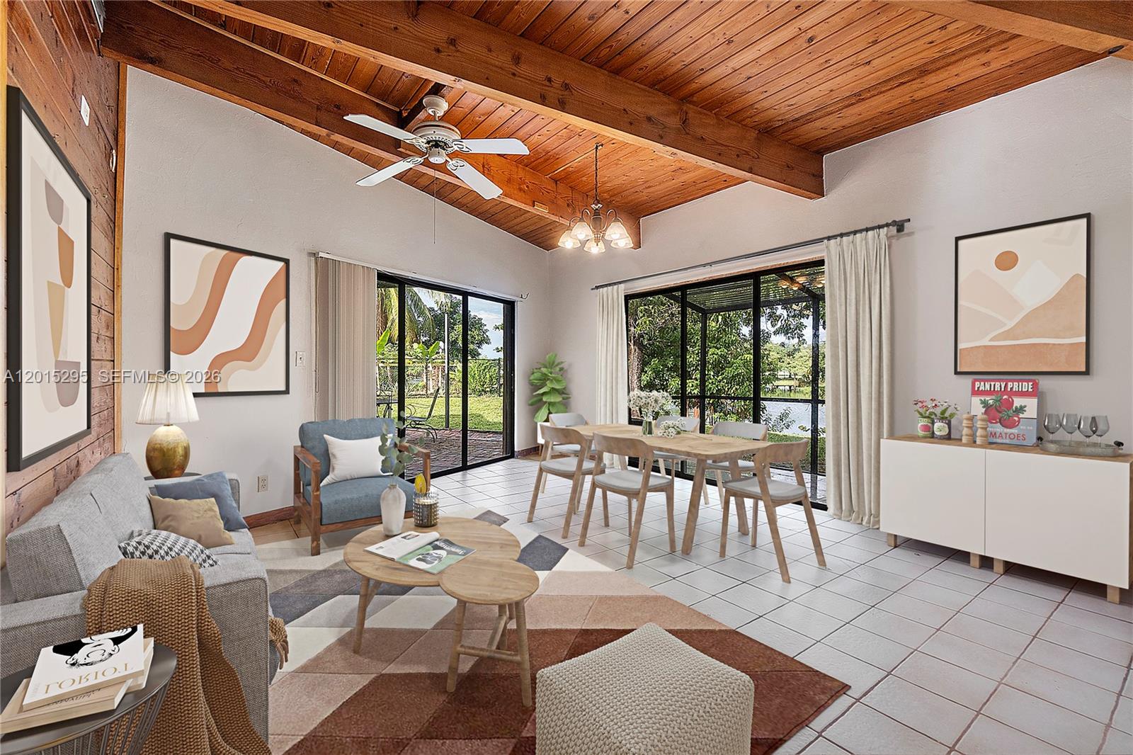 A living and dining area features a wood-beamed ceiling, tile floors, and large sliding glass doors — 4561 NW 79th Ave, Lauderhill FL 33351, LAUDERHILL, FL