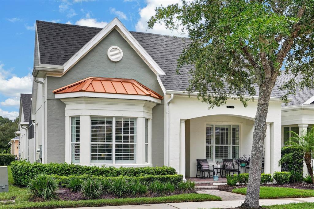 A one-story house features a gray and white exterior with a copper-roofed bay window — 3434 TORRE BOULEVARD, NEW SMYRNA BEACH, FL